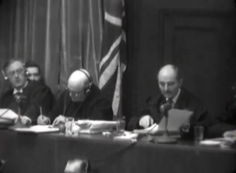 NUREMBERG, GERMANY - 1946: Bench documents - Speaker holds paper at microphone Stock Footage 344901659
