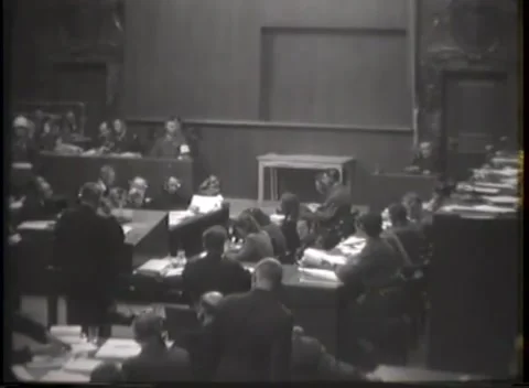 NUREMBERG, GERMANY - 1946: Chamber study - Uniformed official at central desk 動画素材 344490042