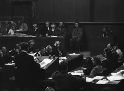 NUREMBERG, GERMANY - 1946: Counsel table - Headset users study papers Stock Footage 343848250