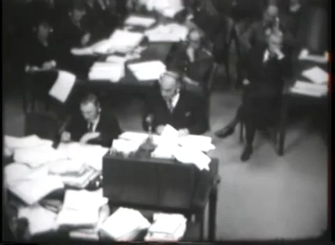 NUREMBERG, GERMANY - 1946: Elevated interior - Paper bundles fill worktables Stock Footage 343848407