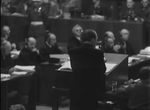 NUREMBERG, GERMANY - 1946: Folded arms - Open bound file fronts listeners Stock Footage 344489389