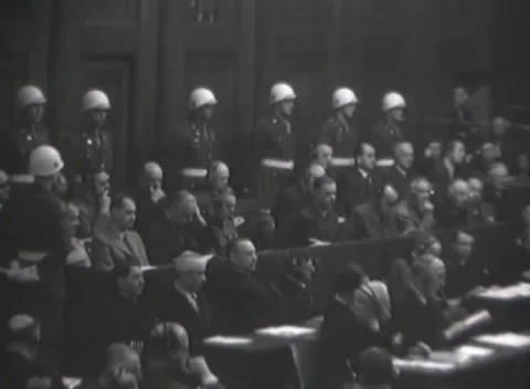 NUREMBERG, GERMANY - 1946: Headset rows - Lawyer handles bound courtroom file Stock Footage 344489378