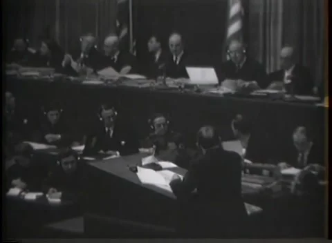 NUREMBERG, GERMANY - 1946: Headset rows - Two members confer over a document Stock Footage 344901565
