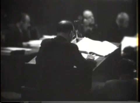 NUREMBERG, GERMANY - 1946: Left-edge figure - Three men face court speaker Stock Footage 344901986