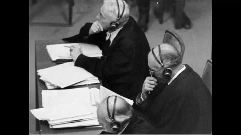 NUREMBERG, GERMANY - 1946: Passing legs - Boots pass behind the counsel 库存影片 344006205