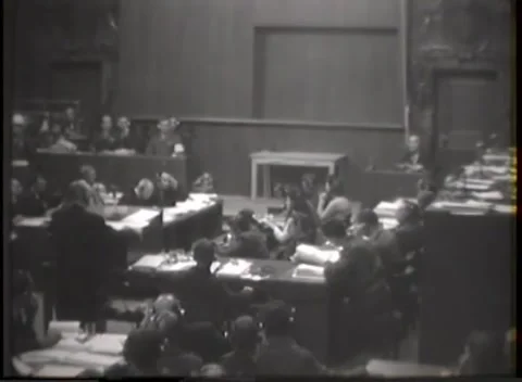 NUREMBERG, GERMANY - 1946: Plaster relief - Standing advocate faces packed desks Stock Footage 344901767
