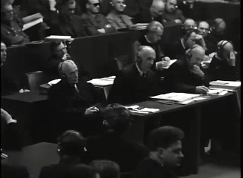 NUREMBERG, GERMANY - 1946: Raised earpiece - Counsel work at document tables Stock Footage 344901268