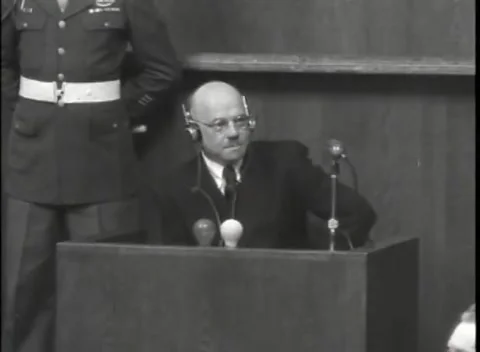 NUREMBERG, GERMANY - 1946: Raised hand near face - Witness and legal team work Stock Footage 344902284