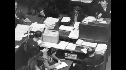 NUREMBERG, GERMANY - 1946: Table pair - Man at the lectern bends to write 스톡 동영상 344006213