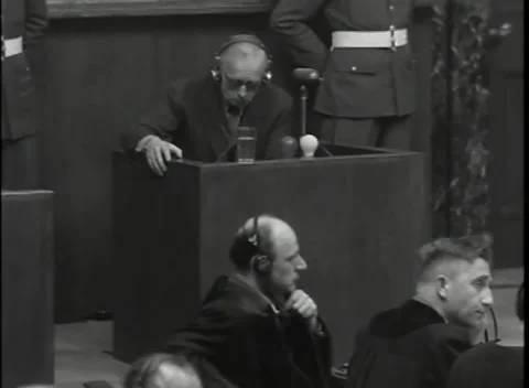 NUREMBERG, GERMANY - 1946: War Crimes Trials — A hand raised to the earpiece 스톡 동영상 342670822