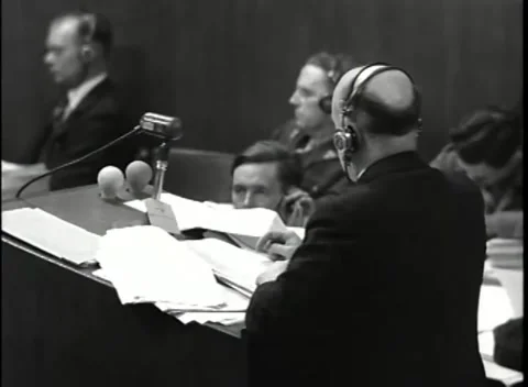 NUREMBERG, GERMANY - 1946: War Crimes Trials — At the paper-strewn lectern Stock Footage 342670837