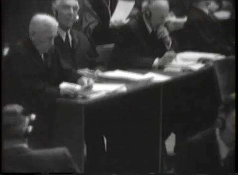 NUREMBERG, GERMANY - 1946: War Crimes Trials — Robed men writing at the bench Stock Footage 342818610