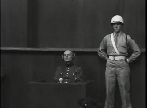 NUREMBERG, GERMANY - 1946: War Crimes Trials — Two-shot with the guard on post Stock Footage 342818762