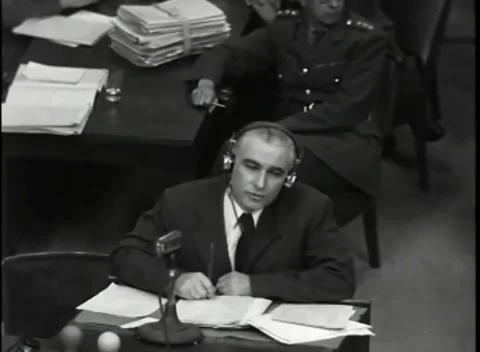 NUREMBERG, GERMANY - 1946: War Crimes Trials — Braided officer behind the table Stockbeeldmateriaal 342819013