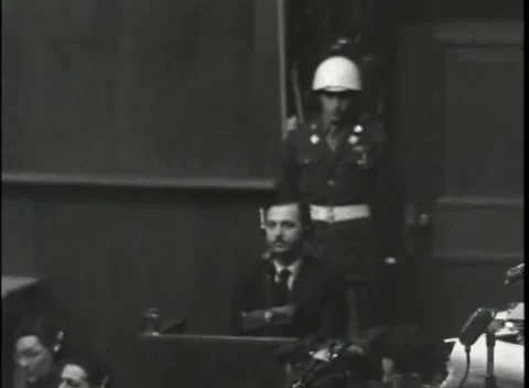 NUREMBERG, GERMANY - 1946: War Crimes Trials — Seated witness in a headset Видео 342920628