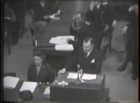 NUREMBERG, GERMANY - 1946: War Crimes Trials — Two at the desk, documents behind Stock Footage 342920932