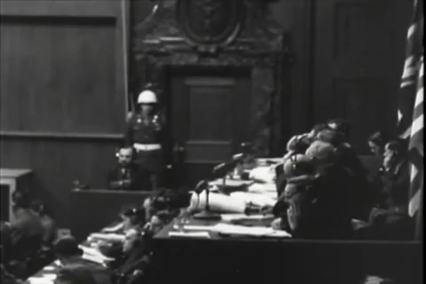 NUREMBERG, GERMANY - 1946: Working bench - Staff study papers near witness box Stock Footage 344489497