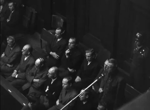 NUREMBERG, GERMANY - 1947: Arraignment — Dock view turns to headphoned judge Vidéo 343320788