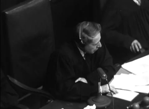 NUREMBERG, GERMANY - 1947: Arraignment — Typed pages beside bench microphone Vidéo 343320790