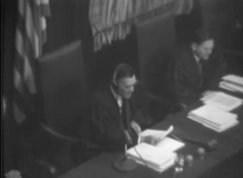 NUREMBERG, GERMANY - 1947: Flagged bench - Official reads near vacant chair Vídeo Stock 344490594