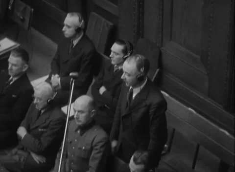 NUREMBERG, GERMANY - 1947: Occupant - Two dock rows listen by headphones Stock Footage 344489017