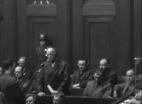 NUREMBERG, GERMANY - 1947: Receiver - Older headset user stands at microphone Stock Footage 344490673