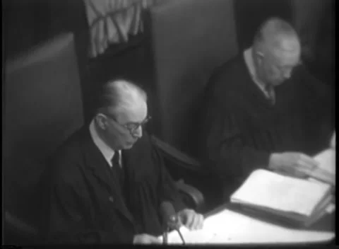 NUREMBERG, GERMANY - 1947: Spread hand - Robed pair reads from bound volume Stock Footage 344489098