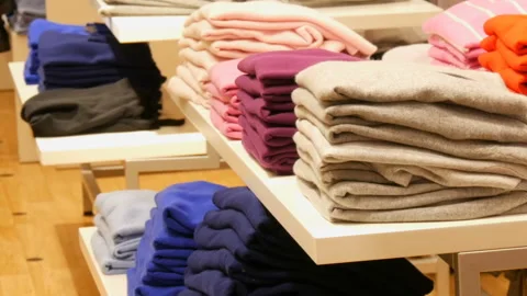 Nuremberg, Germany - December 3, 2018: Stylish clothes stacked on the shelves in Stock Footage 101101205
