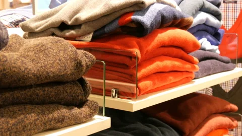 Nuremberg, Germany - December 3, 2018: Stylish clothes stacked on the shelves in Stock Footage 101101815