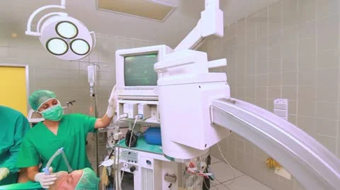 Nurse adjusting a monitor next to a patient Stock Footage