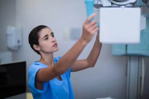 Nurse adjusting x-ray machine Stock Photos