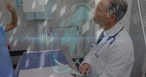 Nurse adjusting x-ray triggers doctor reviewing chart while animated data stream Stock Footage 310972328