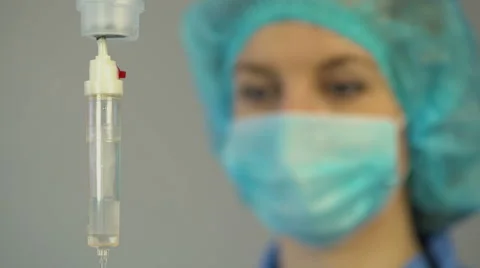 Nurse anesthetist checking drop counter, taking care of patient after surgery Stock Footage 62701783