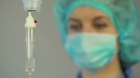 Nurse anesthetist checking drop counter, taking care of patient after surgery Stock Footage 62707411