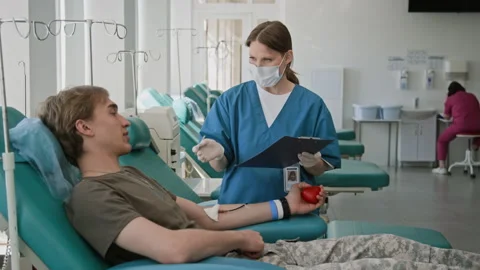 Nurse Asking Man his Personal Information to File Document Before Donating Blood Stock Footage 317383447