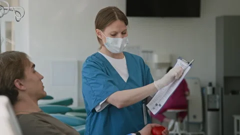Nurse Asking Man to Sign Documents Before Donating his Blood Stock Footage 317383471