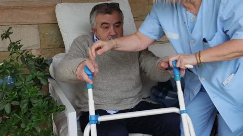 Nurse Assisting Elderly Man with Walker Stock Footage 300171927