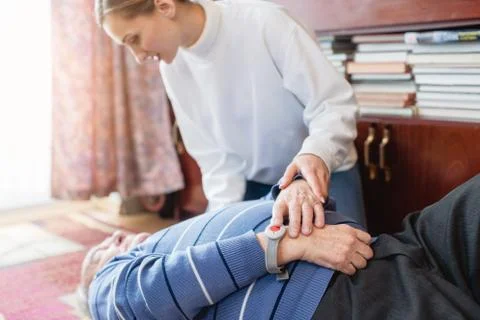 Nurse in assisting living program finding senior lying on the floor Stock Photos