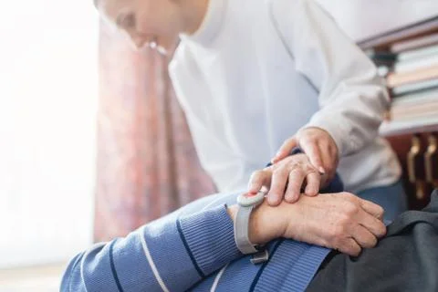 Nurse in assisting living program finding senior lying on the floor Stock Photos