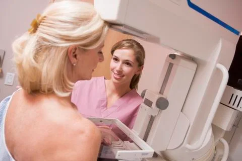 Nurse assisting patient undergoing mammogram Stock Photos