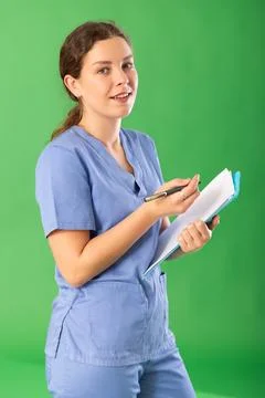 Nurse in blue uniform takes notes on documents while interviewing virtual Stock Photos