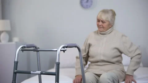 Nurse bringing patient walking frame, rehabilitation after hip joint replacement Stock Footage 102415128