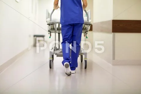 Nurse carrying hospital gurney to emergency room Stock Photos