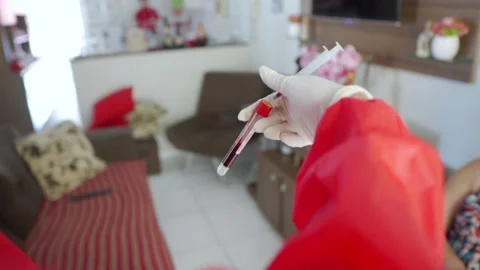 Nurse checking blood test for corona virus at a patient's home Stock Footage 153344969