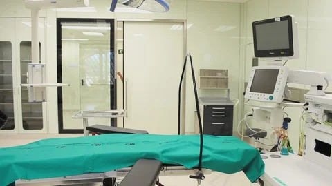 Nurse checking cables of monitors in modular operating theatre. 스톡 동영상 129896216