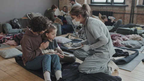 Nurse Checking on Refugee with Child Stock Footage 195286705