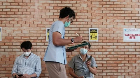 Nurse checks coronavirus vaccination queue. Stock Footage 157087865