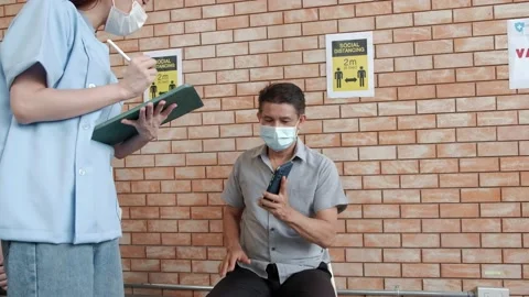 Nurse checks coronavirus vaccination queue. Stock Footage 158070803