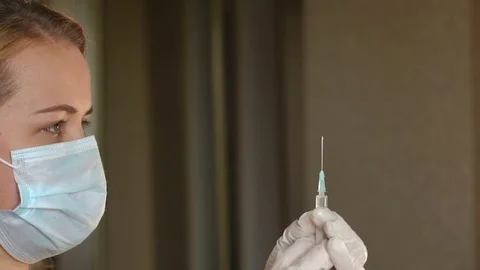 Nurse checks the medicine in the syringe,close-up. Stock Footage