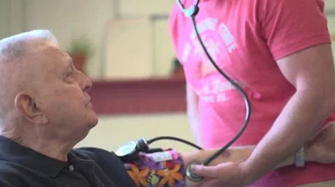 Nurse checks old man's pulse Stock Footage 10716812